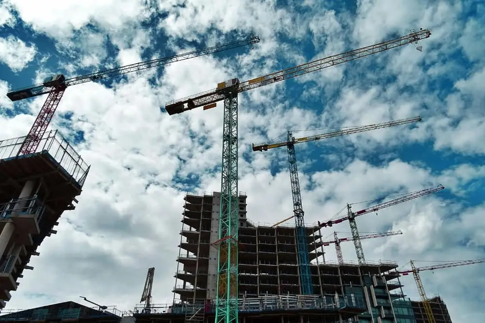 A sky shot of cranes and buildings in the construction process